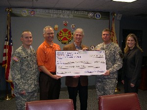 In December, Col. Joe Yavorsky, USA (Ret.) (2nd from l), chapter president, presents Jim Greene (c), director of Family and Morale, Welfare and Recreation for Fort Gordon, and Col. Glenn Kennedy II, USA (2nd from r), garrison commander, with a $4,000 check for the Fort Gordon Christmas House as Sgt. Maj. Steve Caffee, USA (Ret.) (l), chapter member, and Sarah Crow from the Augusta Chapter of the Association of the United States Army, look on.